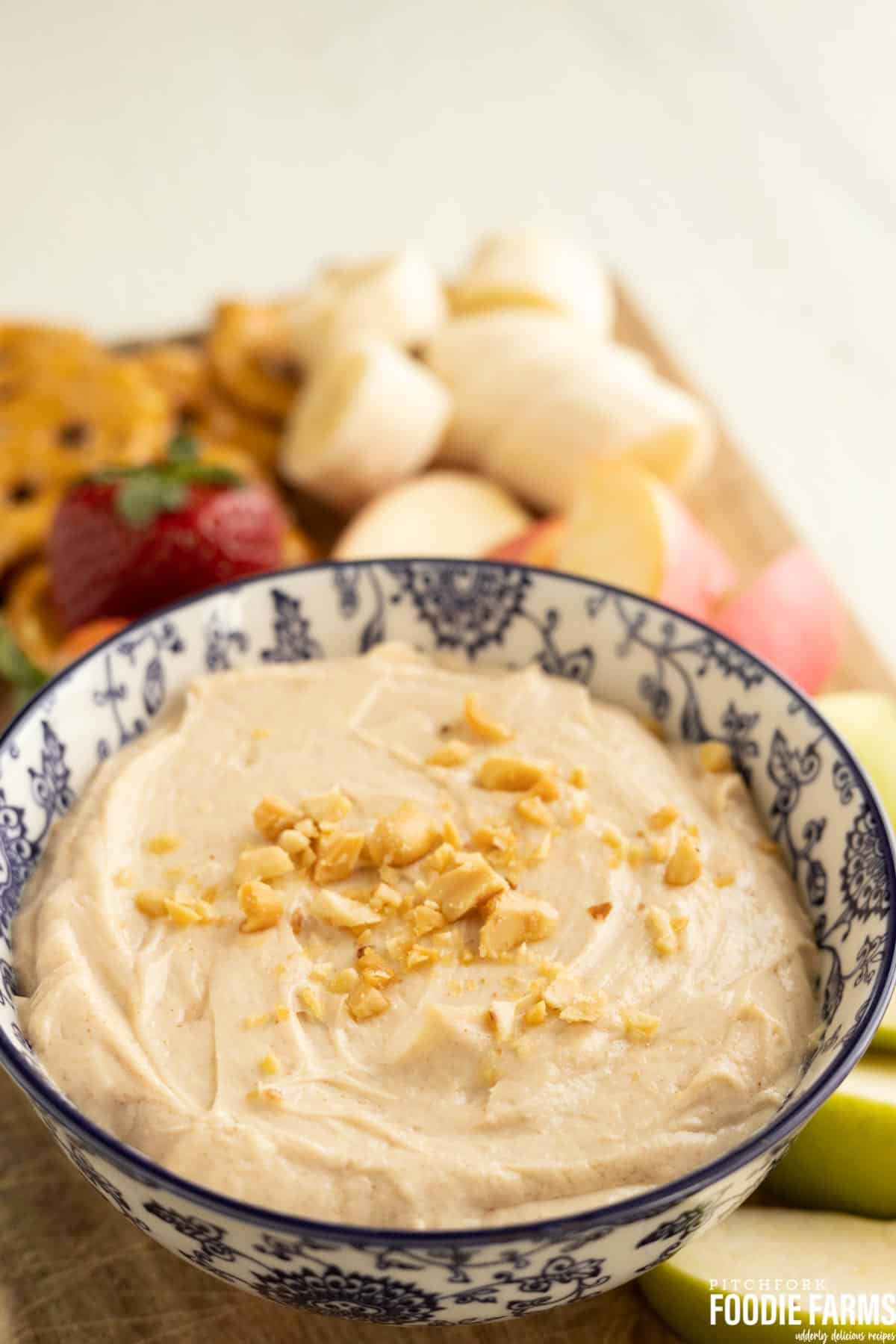 Peanut butter dip with sliced apples and fresh fruit.