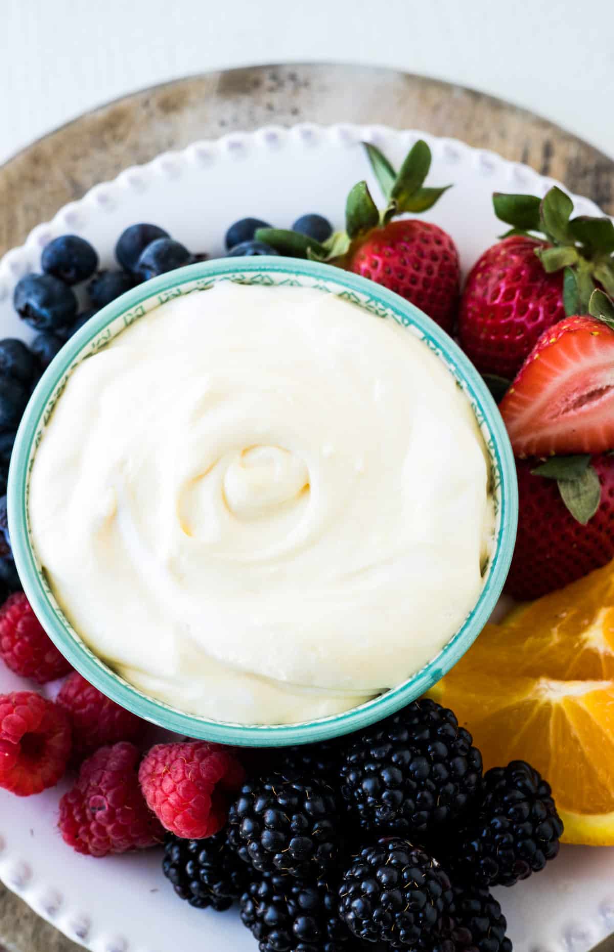 Fluffy fruit dip with fresh fruit on a serving tray.