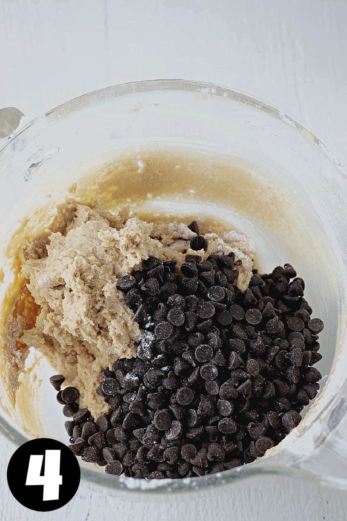 Chocolate chips on top of raw cookie dough.