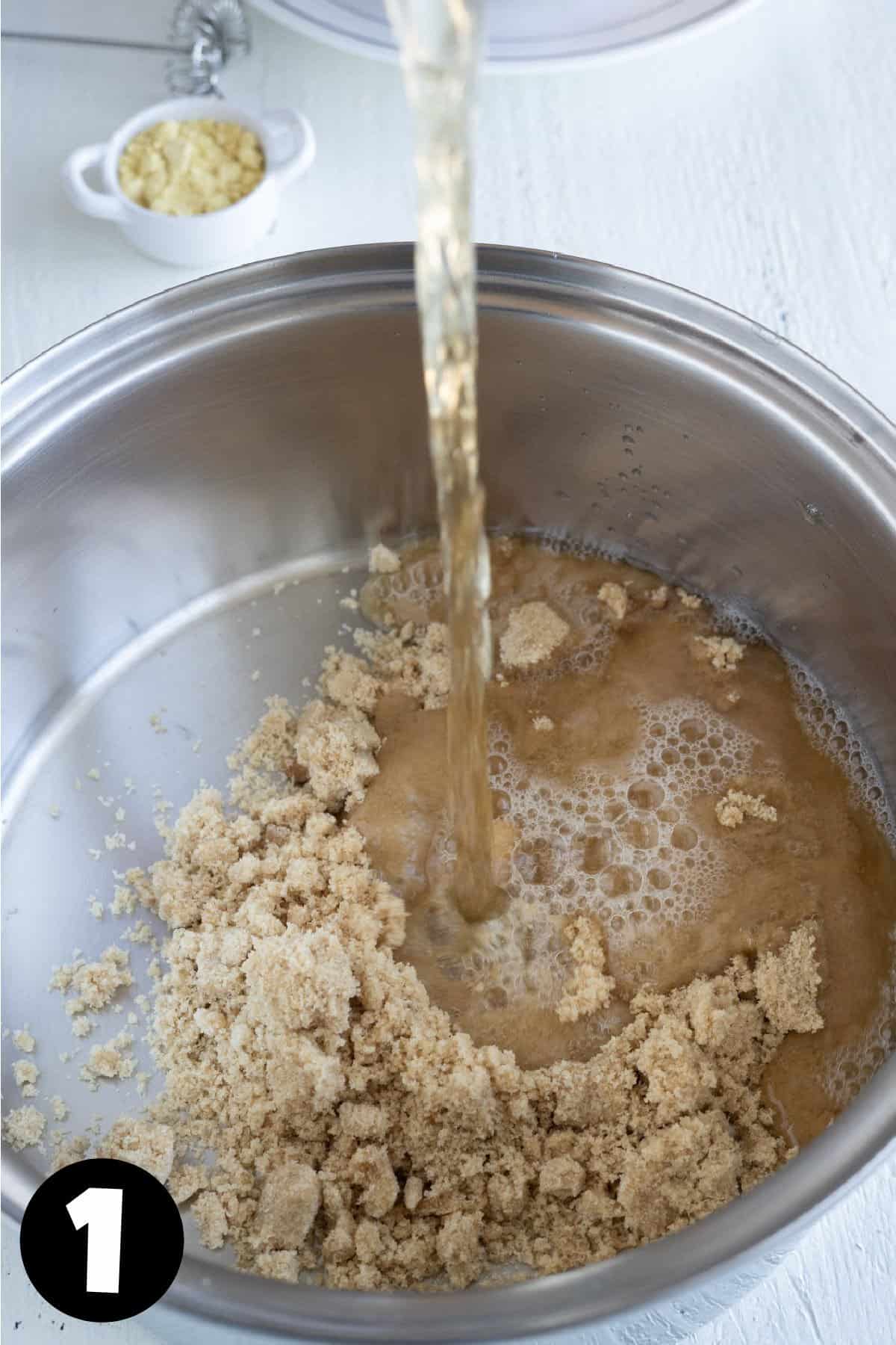 A pot with brown sugar and vinegar being poured in.