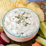 Vegetable dip with fresh dill on the top.