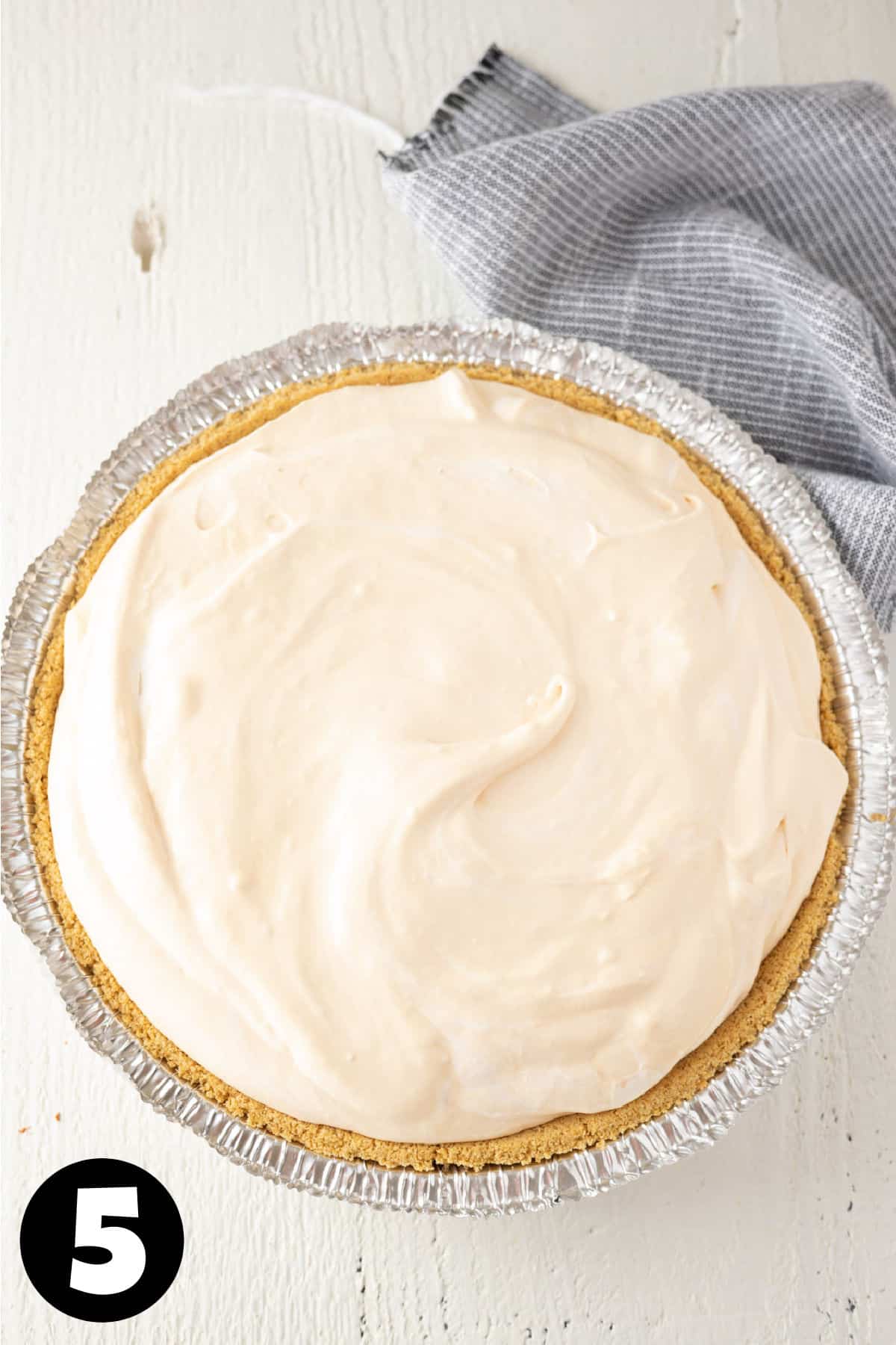 A no bake orange cheesecake in a graham cracker pie crust.