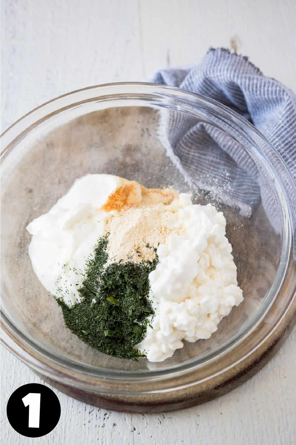 Cottage cheese, yogurt, and seasonings in a bowl to make dill dip.