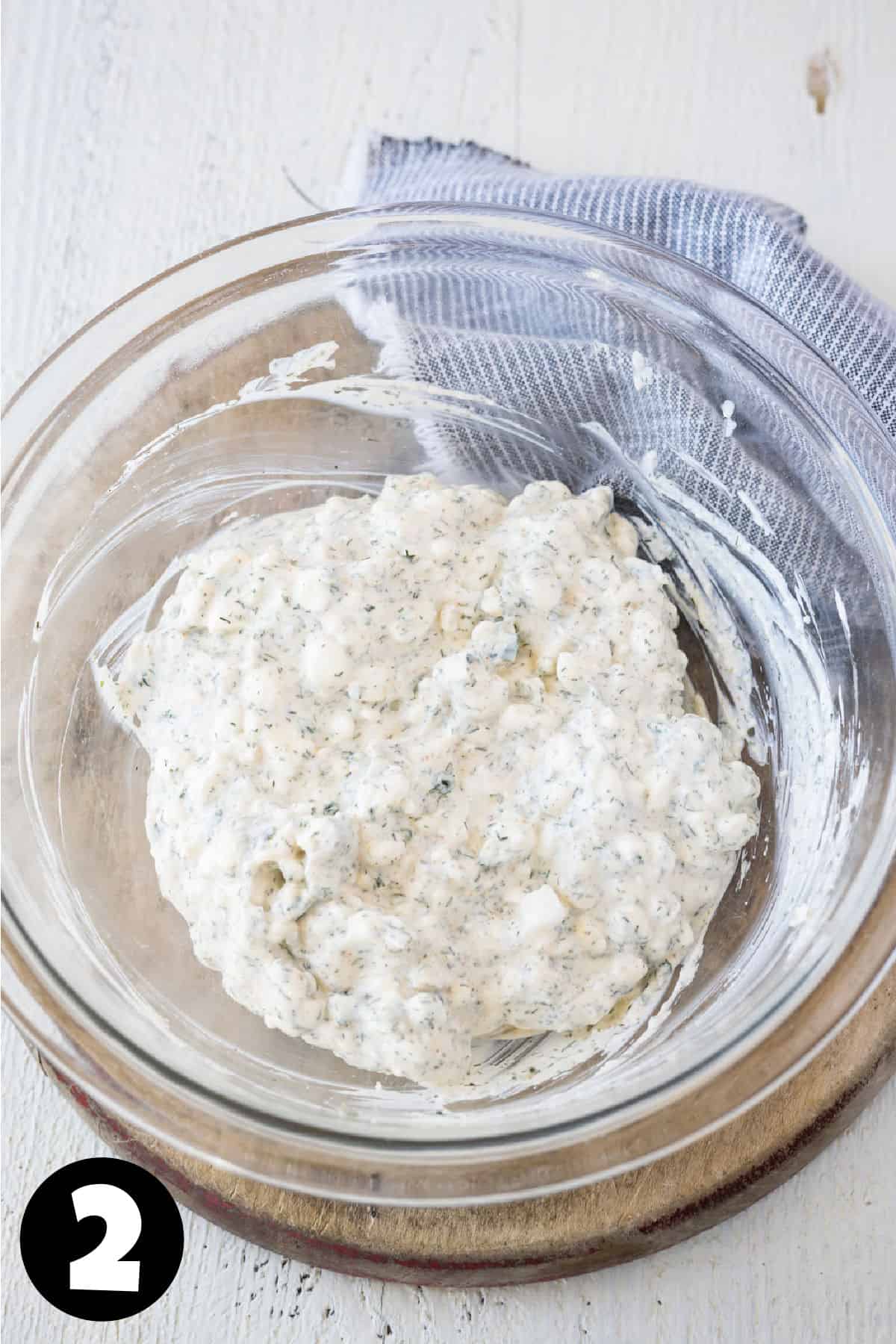 Mixed dill dip in a glass bowl.