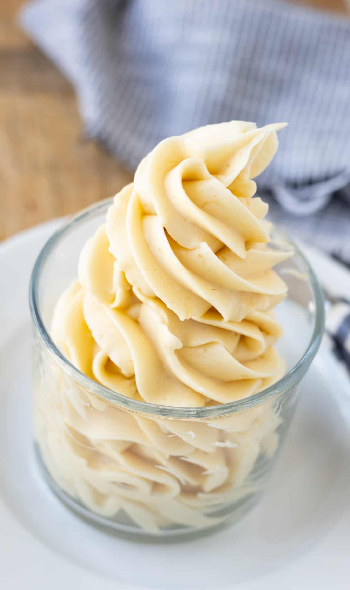 Whipped honey butter piped into a glass jar.