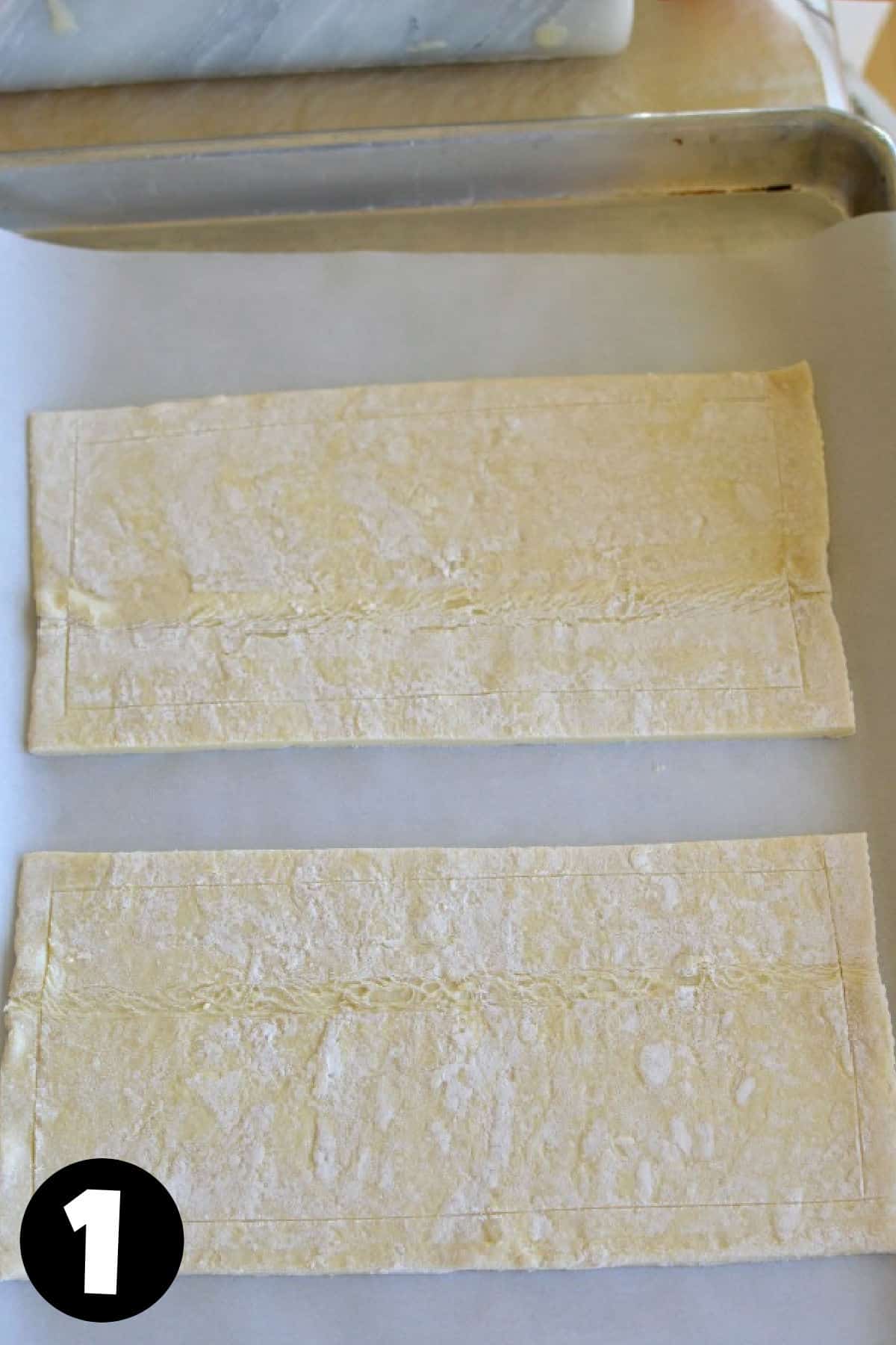 Thawed puff pastry on a baking sheet.