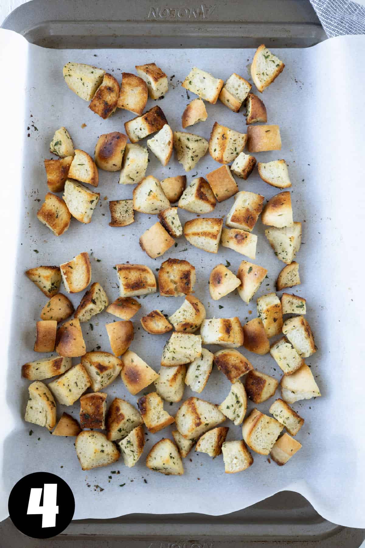 Croutons on a parchment lined baking sheet.