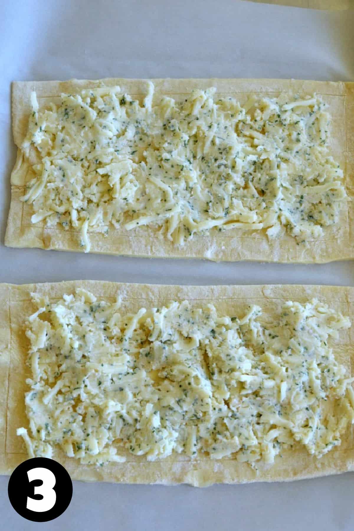 Puff pastry sheets with garlic herb butter and mozzarella cheese spread over it.