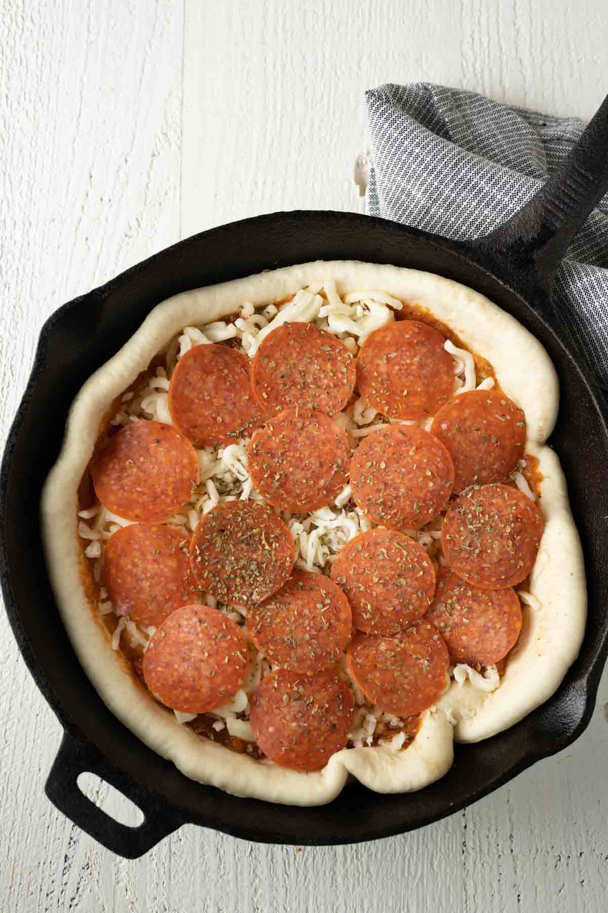 Pepperoni pizza in a cast iron pan. 