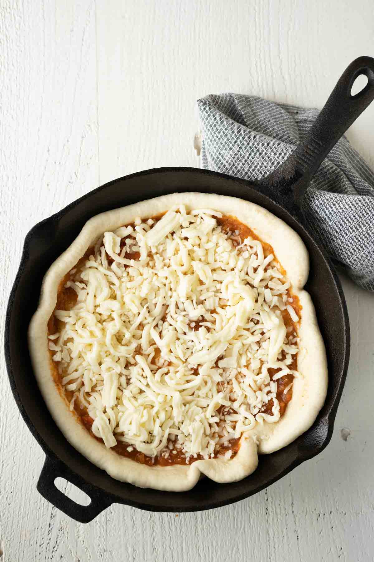Pizza with shredded mozzarella cheese.