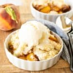 Peach cobbler with fresh peaches and vanilla ice cream.