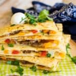 A steal quesadilla filled with bell peppers and sauteed onions and lots of cheese.