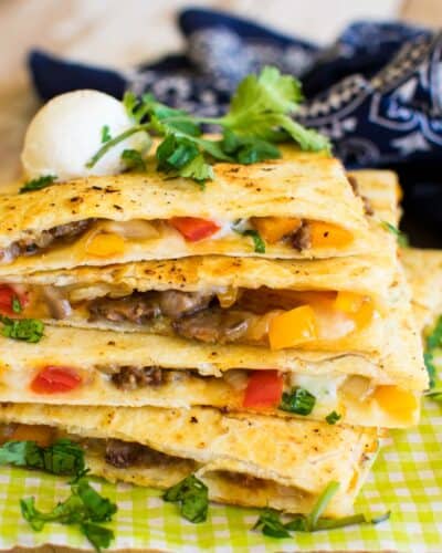A steal quesadilla filled with bell peppers and sauteed onions and lots of cheese.