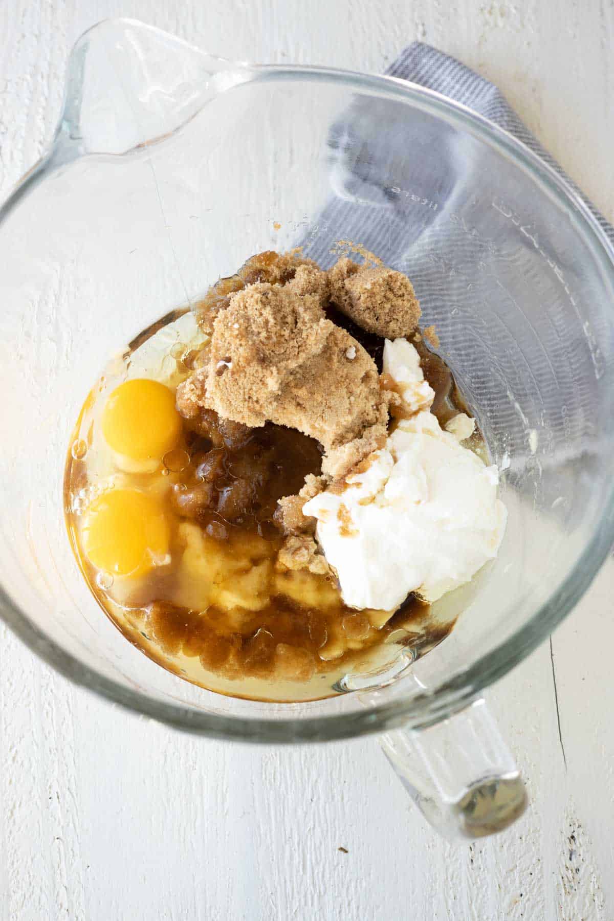 Eggs, brown sugar, and greek yogurt in a mixing bowl.