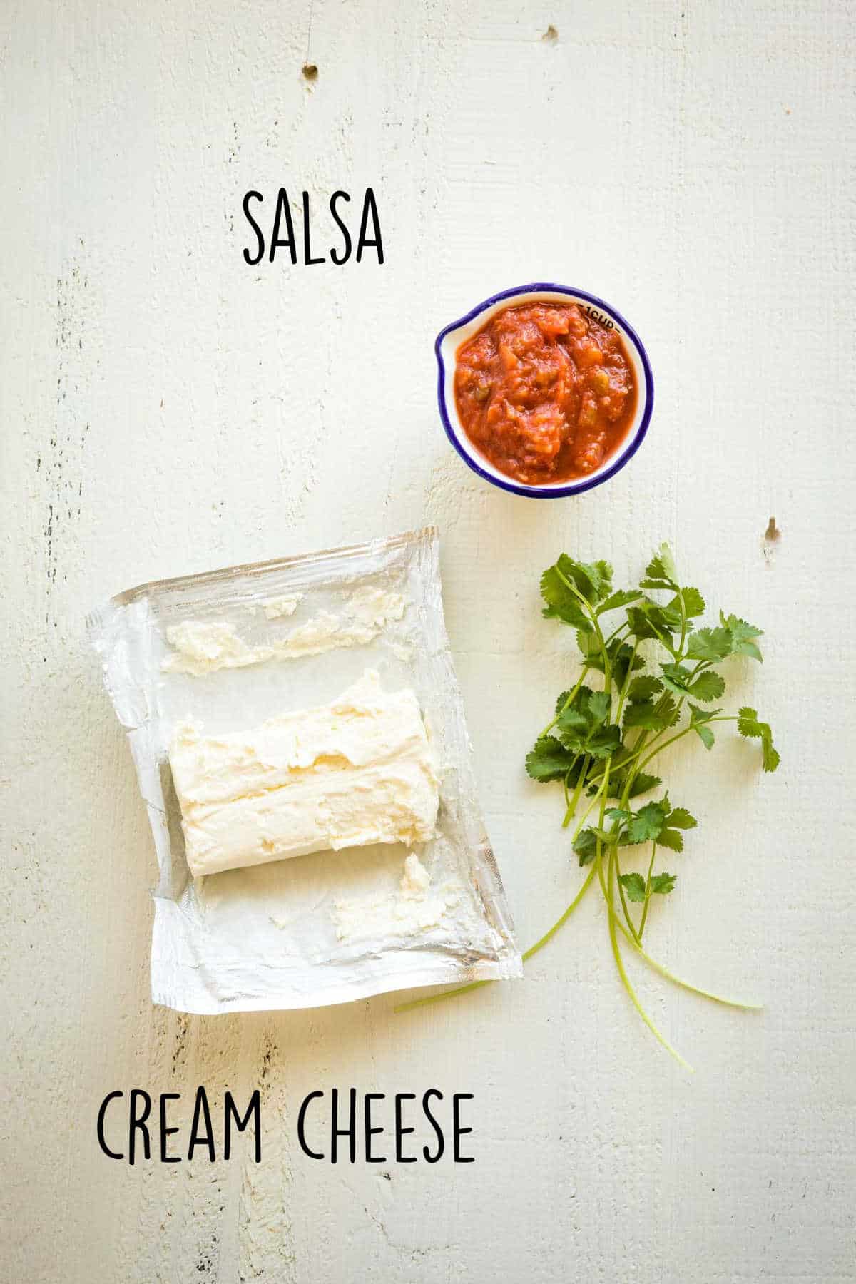 Cream cheese, salsa, and cilantro to make cream cheese salsa.