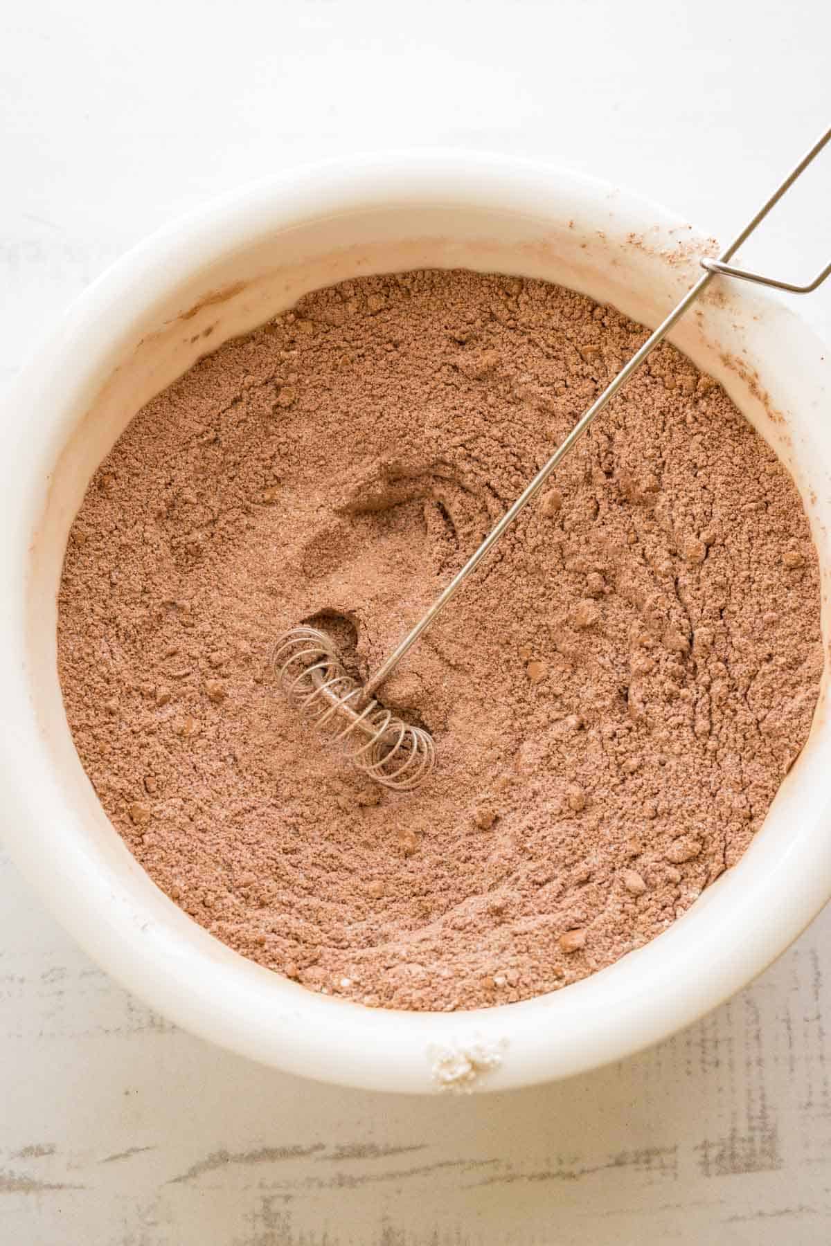 Cocoa, sugar, baking powder, and salt whisked together in a large mixing bowl.