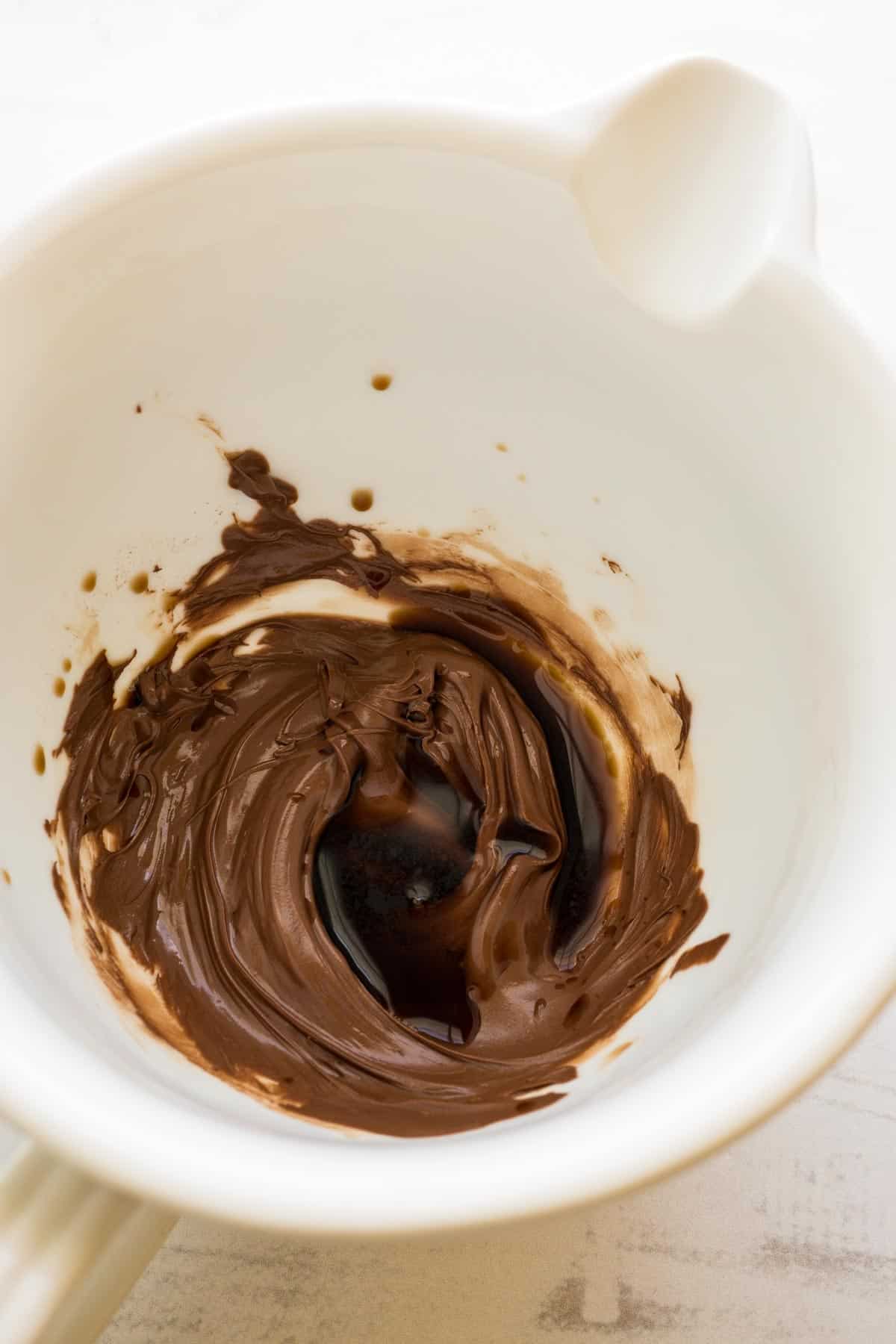 Melted chocolate and vanilla in a white mixing bowl.