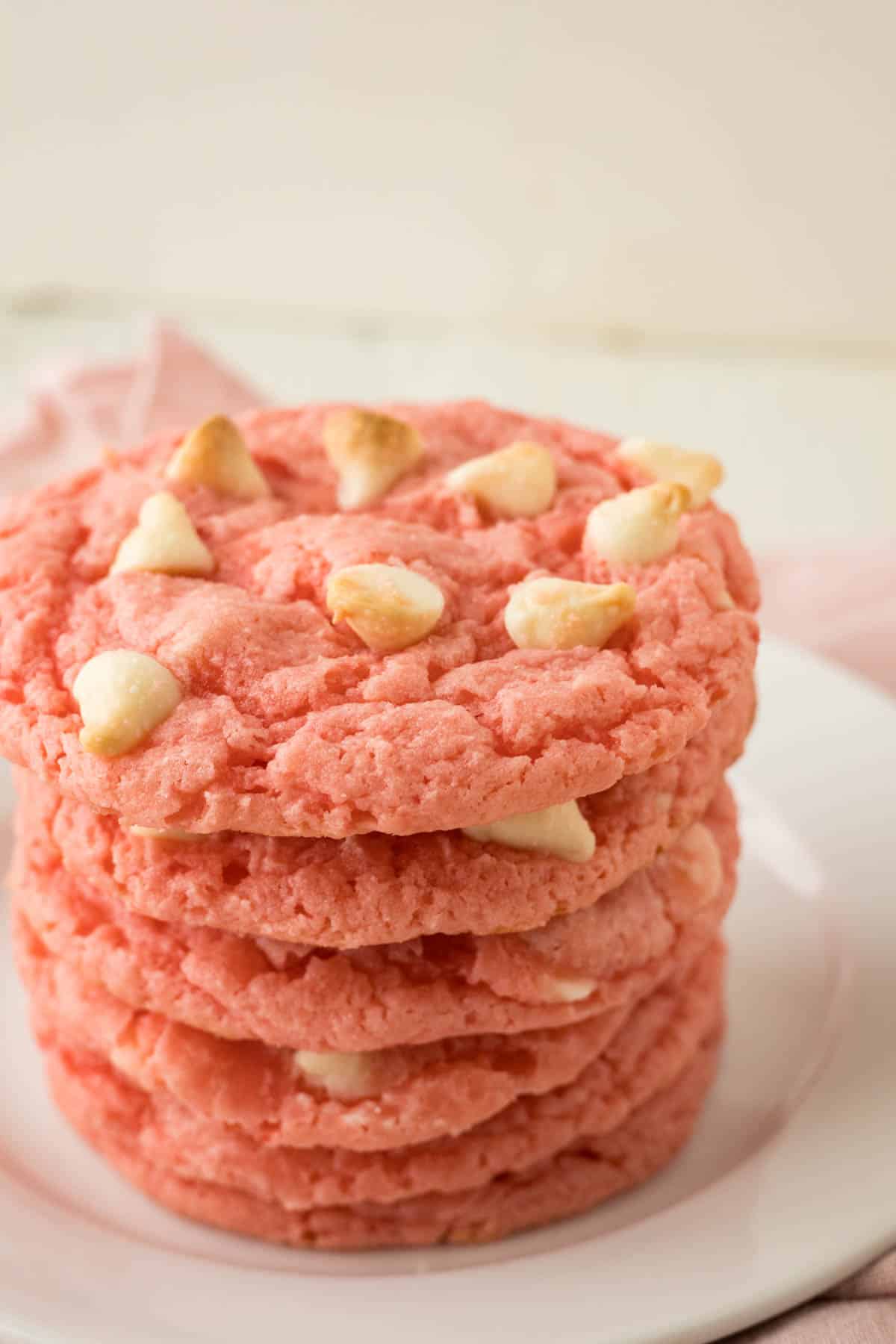 A stack of pink cookies with white chocolate chips made with strawberry cake mix.