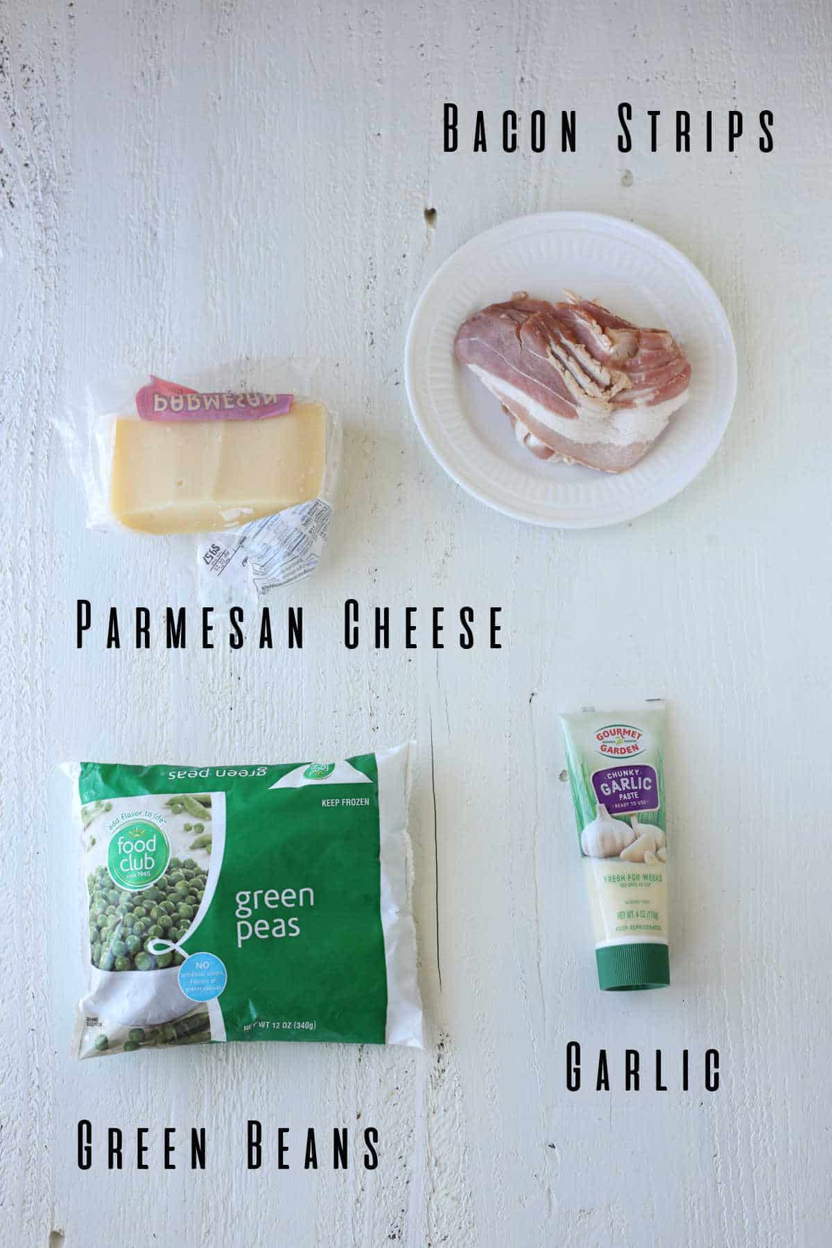 A package of frozen green peas, a tube of garlic paste, slices of bacon, and parmesan cheese.