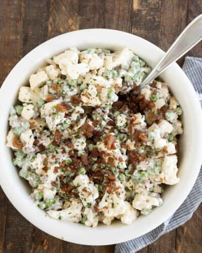 Cauliflower and pea salad with bacon sprinkled on top.