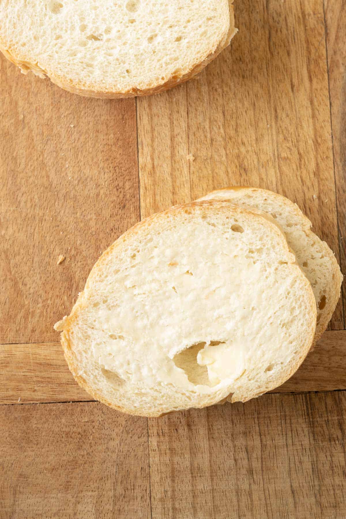 Buttered slices of French bread.