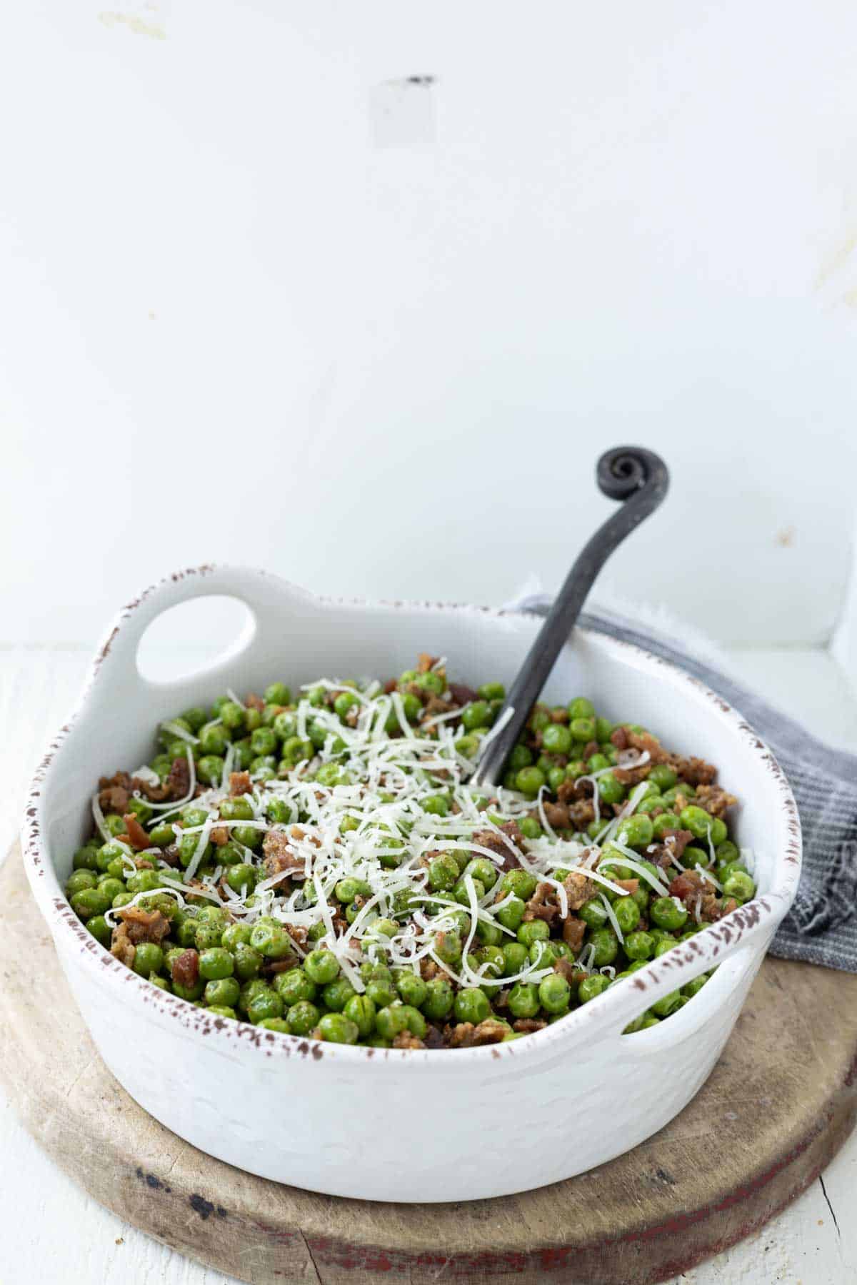 Green peas and bacon topped with grated parmesan cheese.