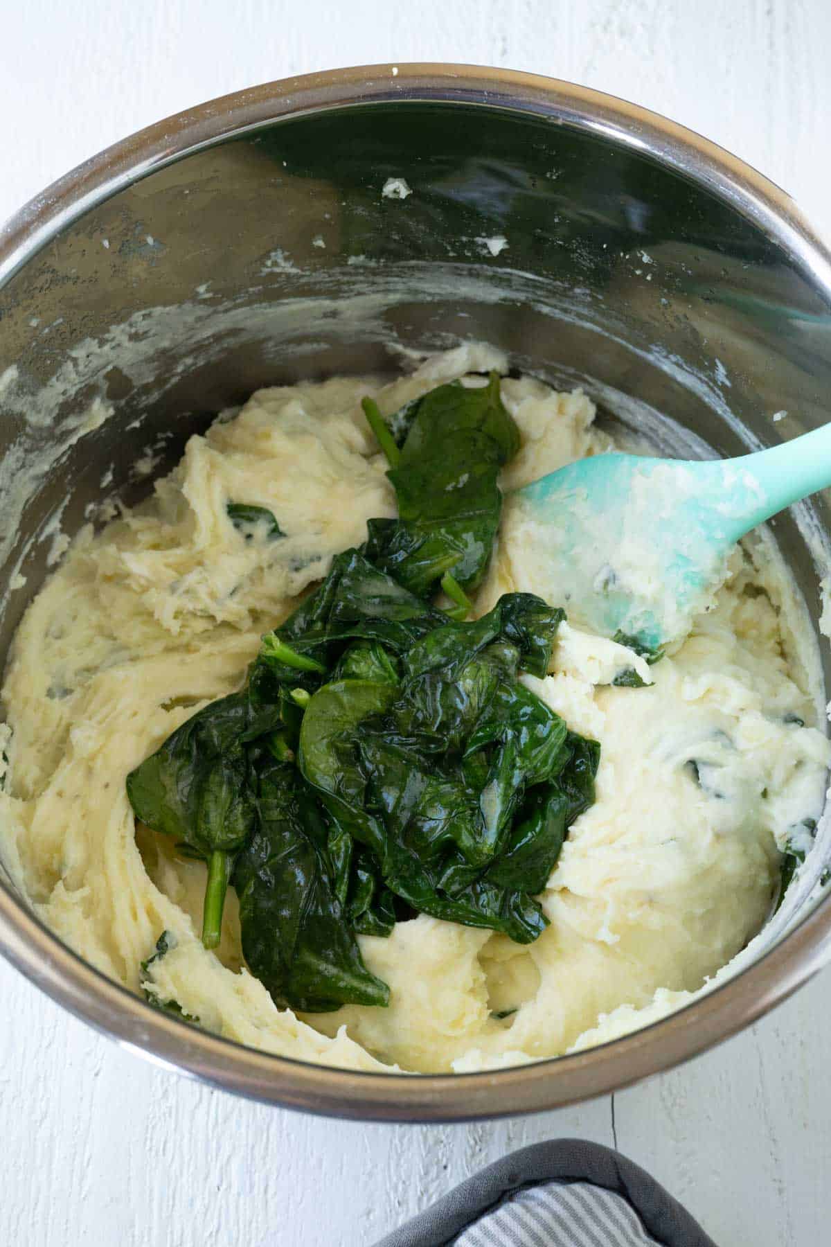 Sauteed spinach and mashed potatoes in a pressure cooker.