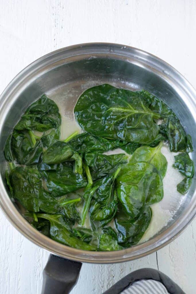 A pan with sauteed spinach.
