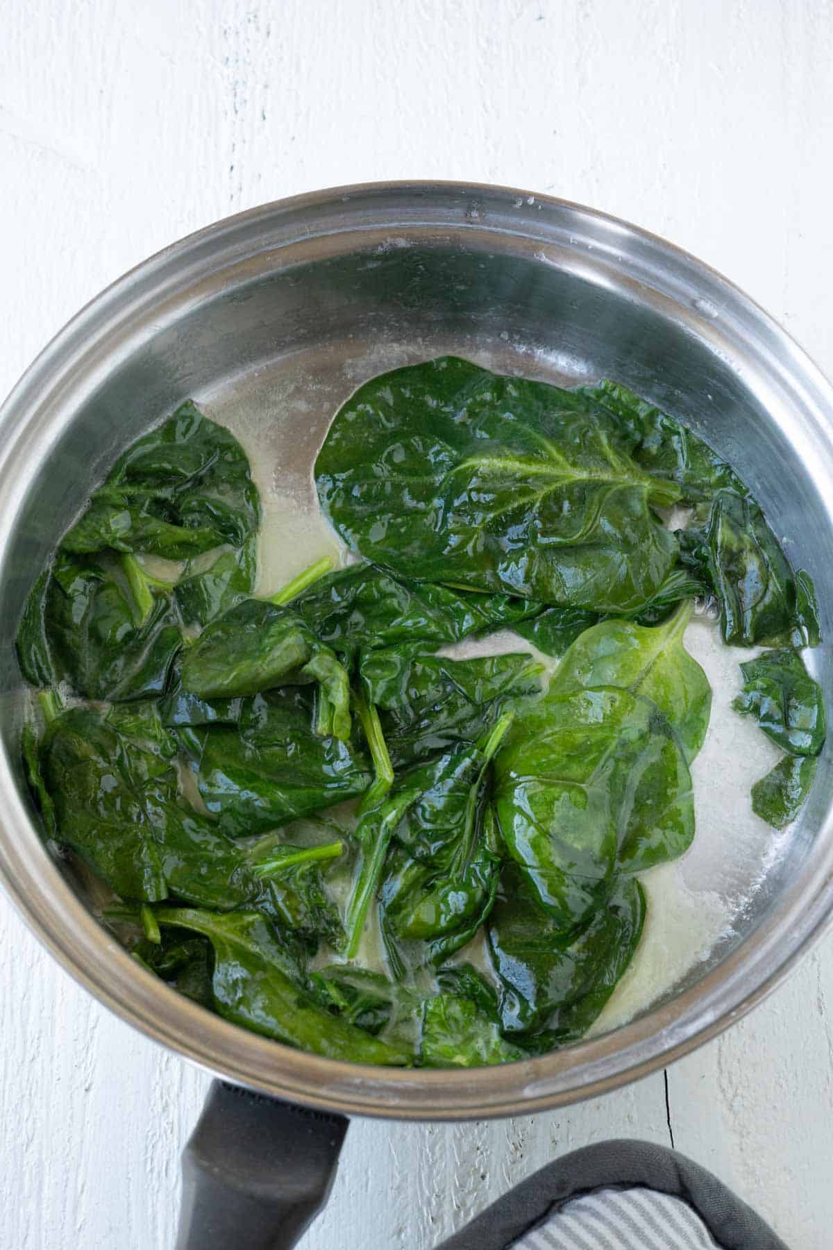 Sauteed spinach in a saucepan.