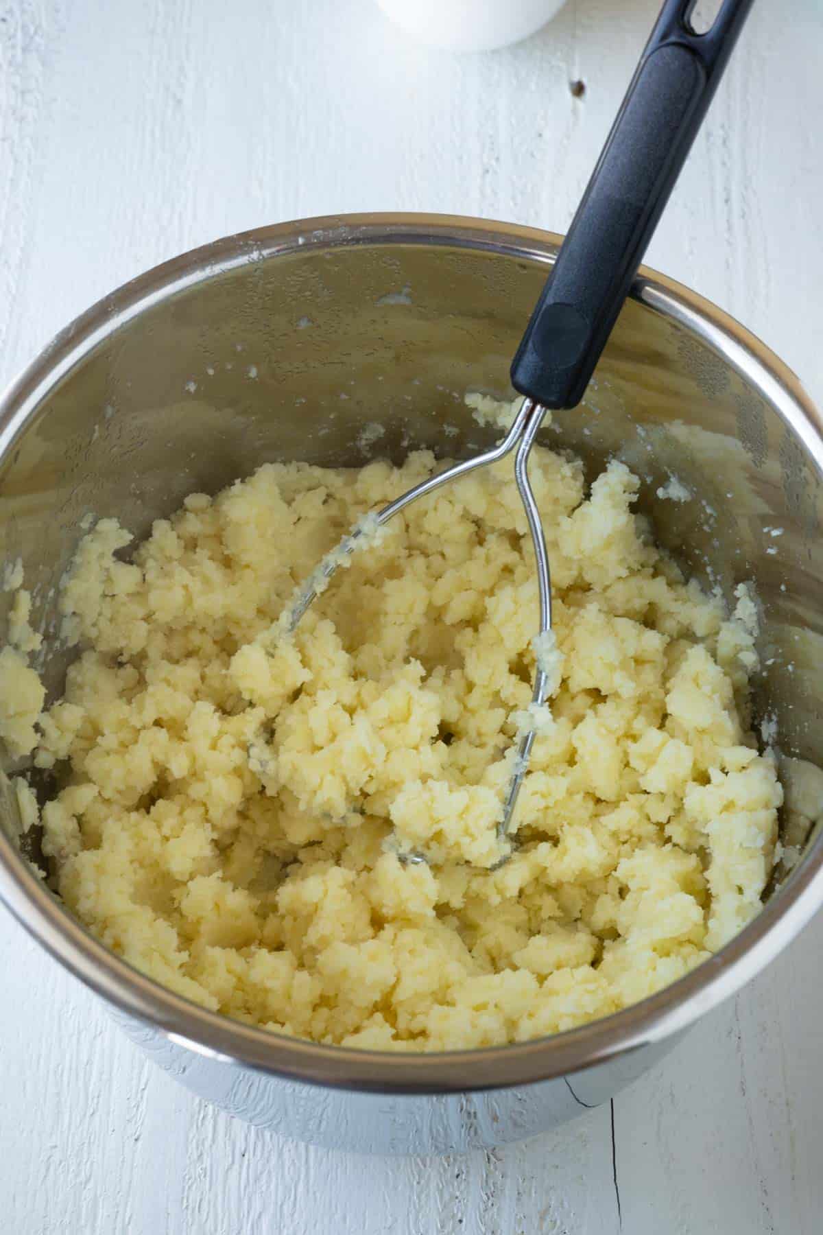 Mashed potatoes with a potato smasher in an instant pot.