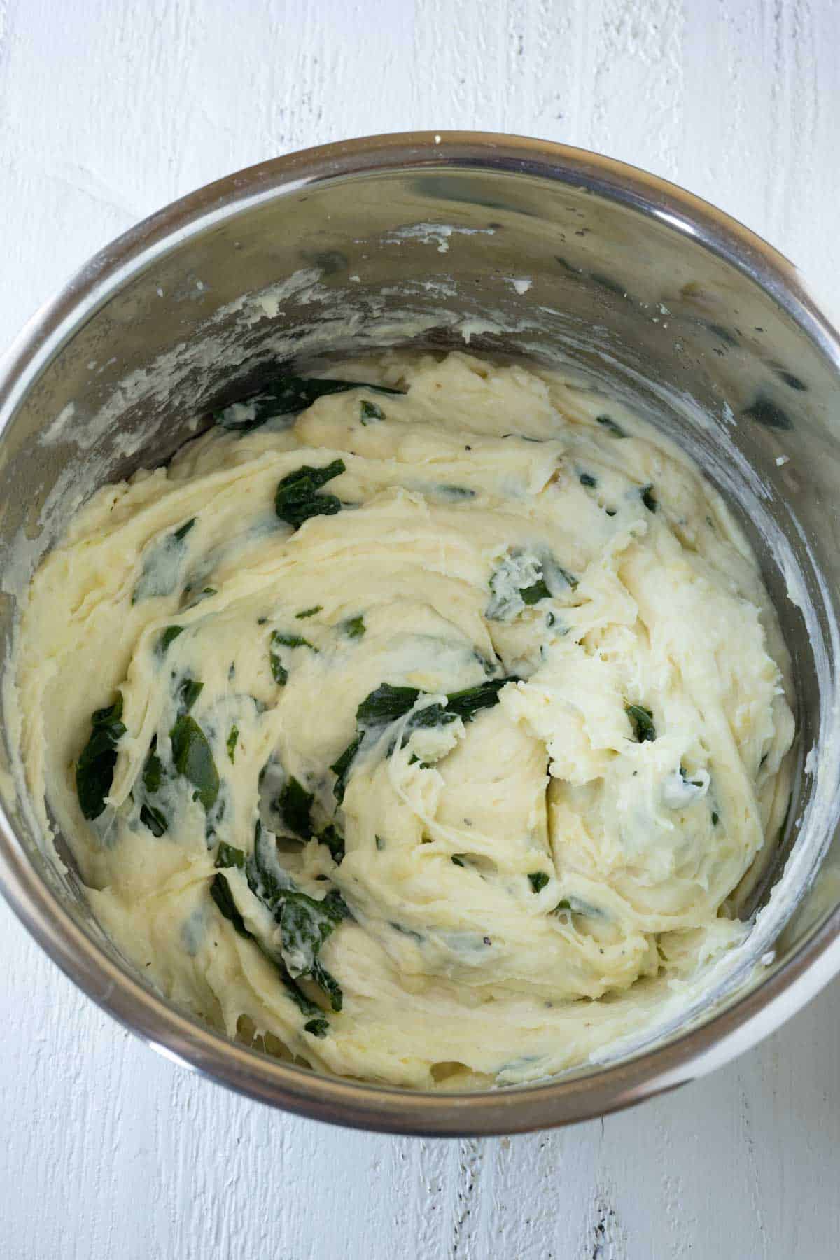 Spinach mashed potatoes in a pressure cooker pan. 