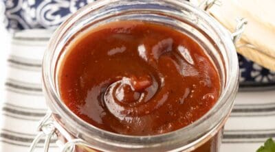 A jar of barbecue sauce that's sweet and tangy.