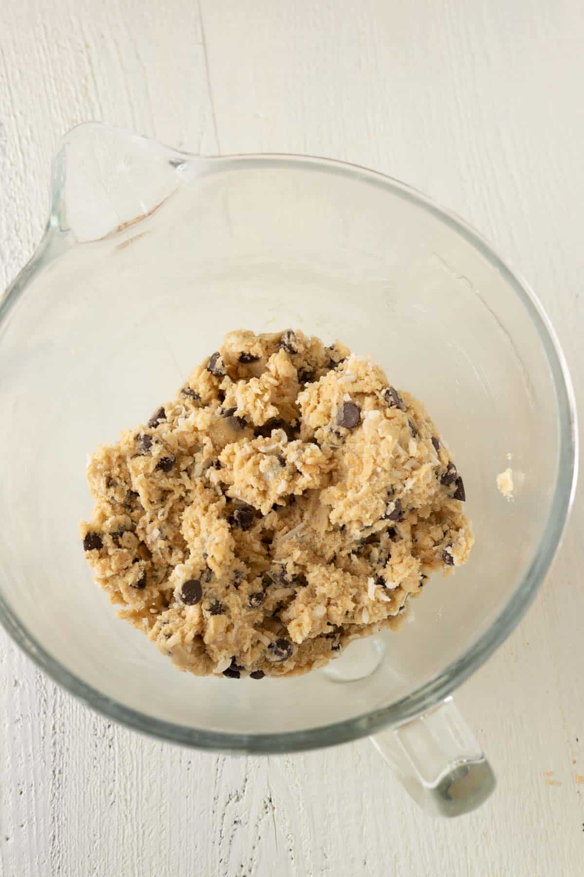 A mixing bowl with chocolate chip cookie dough.