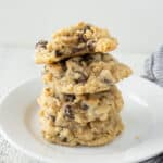 A plate with a stack of rice krispie chocolate chip cookies.