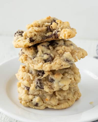 A plate with a stack of rice krispie chocolate chip cookies.