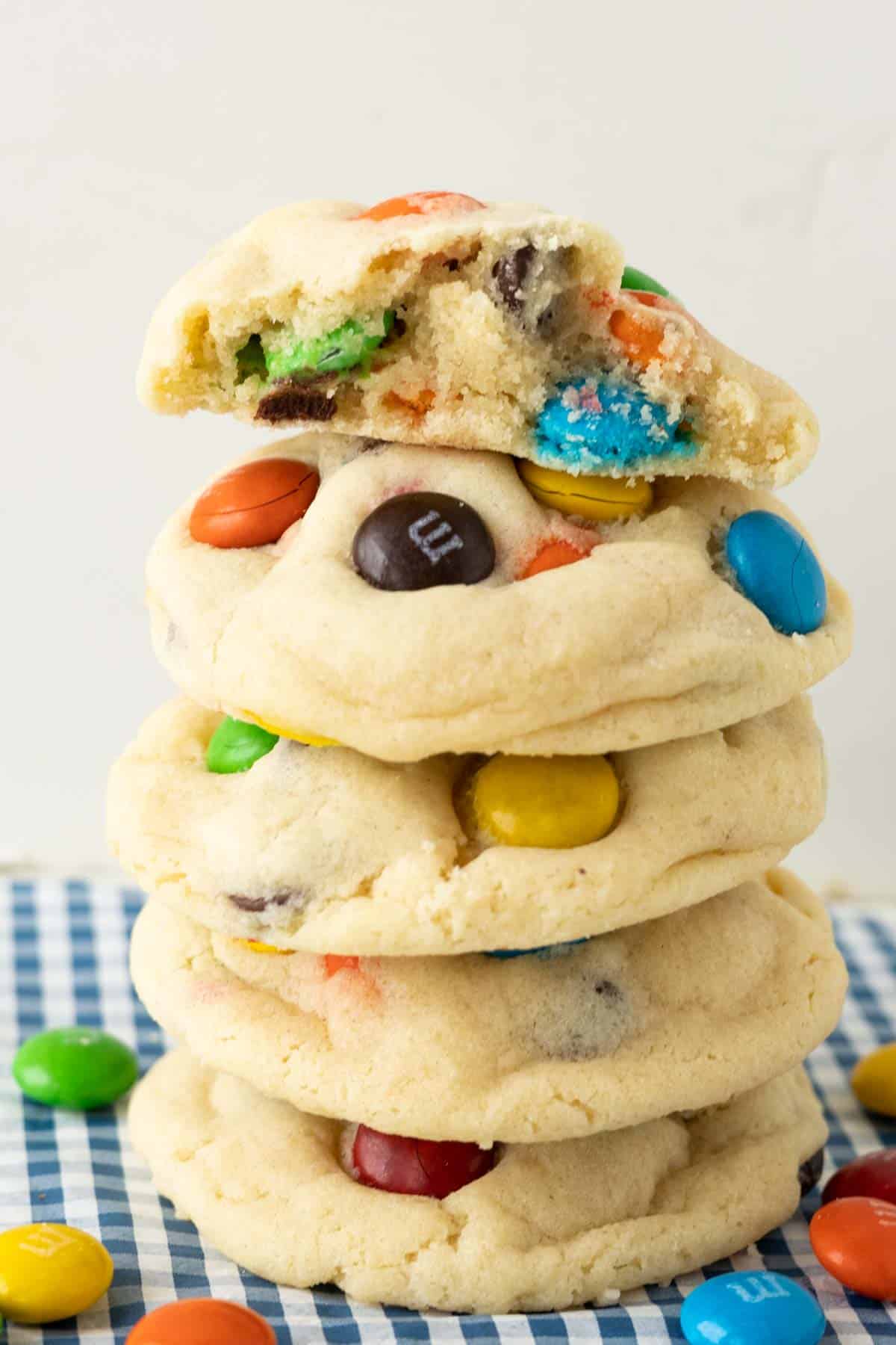 A stack of thick sugar cookies with M&s.