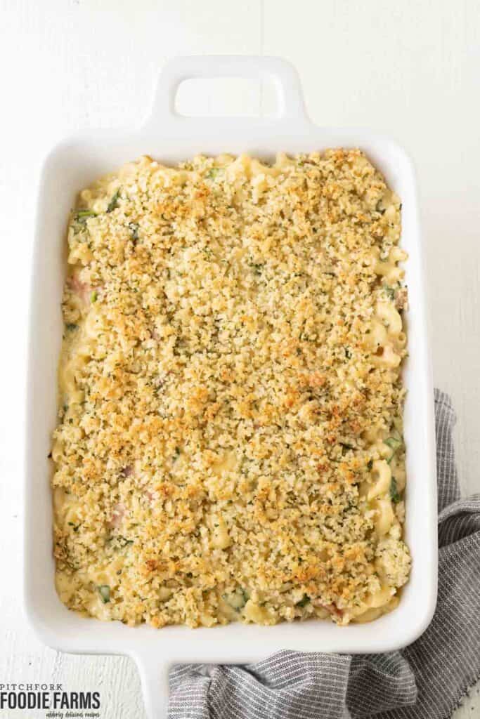 Baked mac and cheese with a bread crumb topping in a casserole dish.