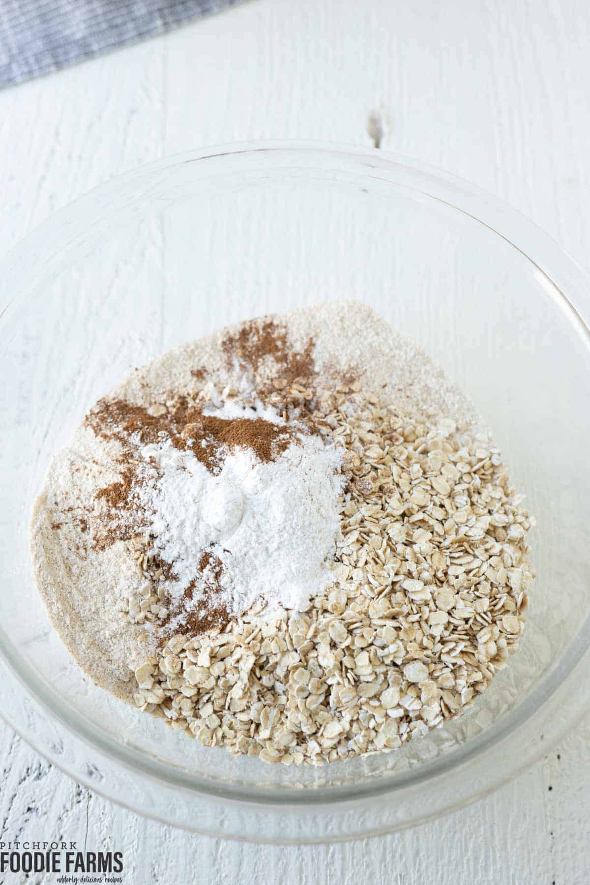 Oats and other dry ingredients needed to make banana muffins.