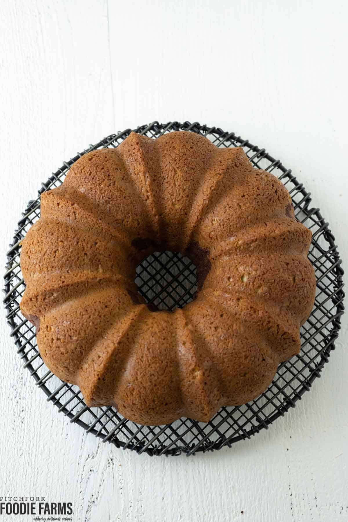 A bundt cake on a wire cooling rack.