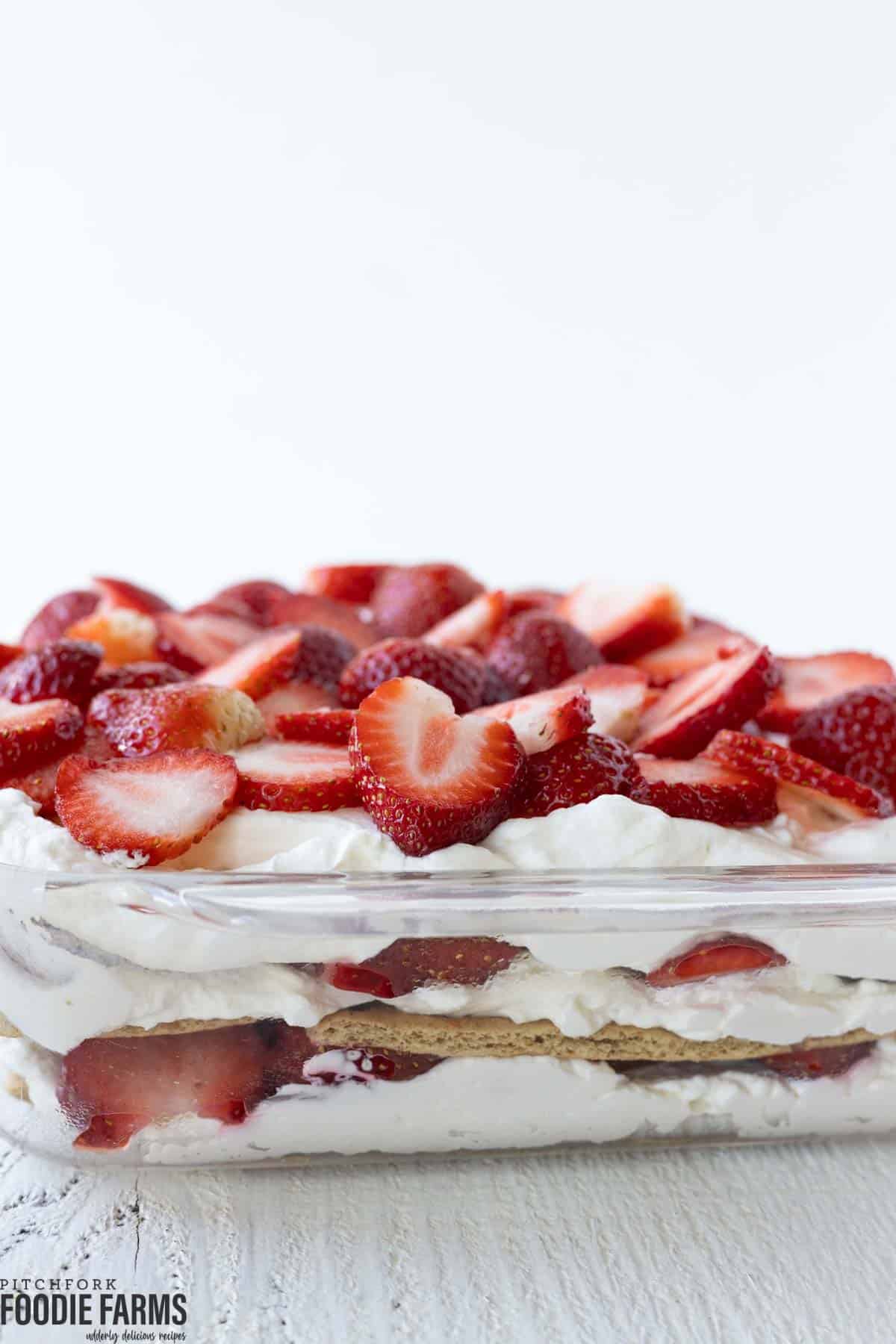 A no bake strawberry icebox cake in a glass baking dish.