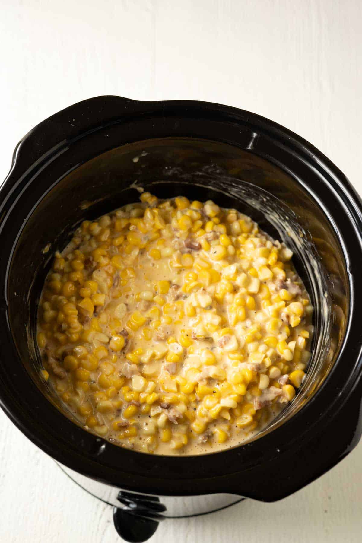 Cooked cheesy corn in a slow cooker.