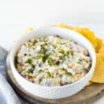 A white bowl with skinny poolside dip made with cream cheese and veggies