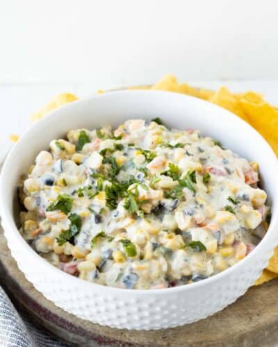 A white bowl with skinny poolside dip made with cream cheese and veggies