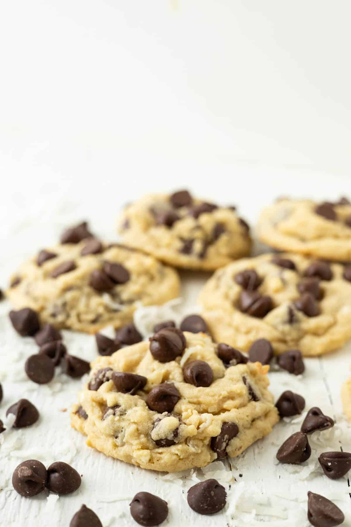 Chocolate chip cookies with coconut on a white tray.