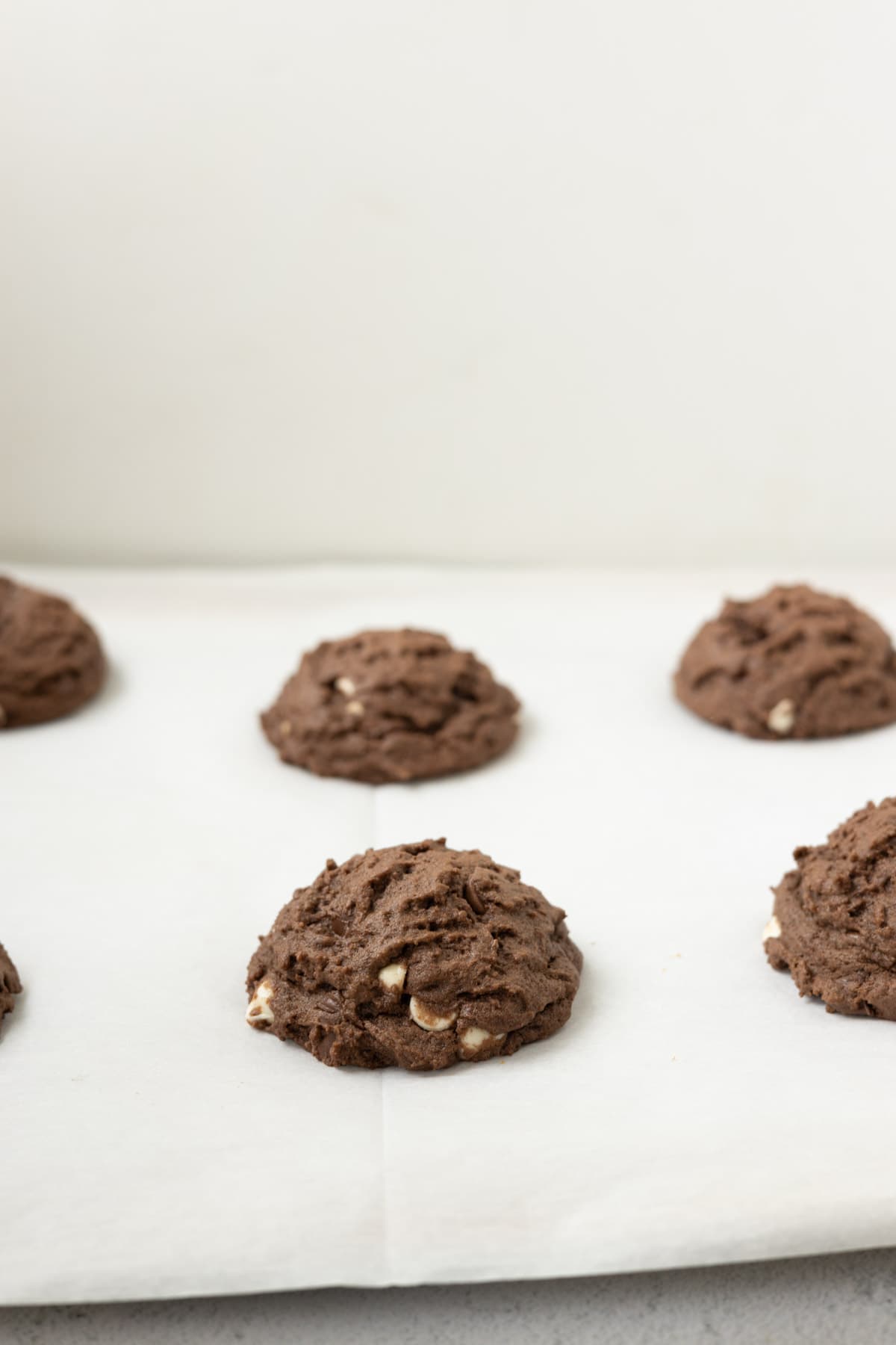 Baked chocolate chocolate chip cookies on a baking sheet.