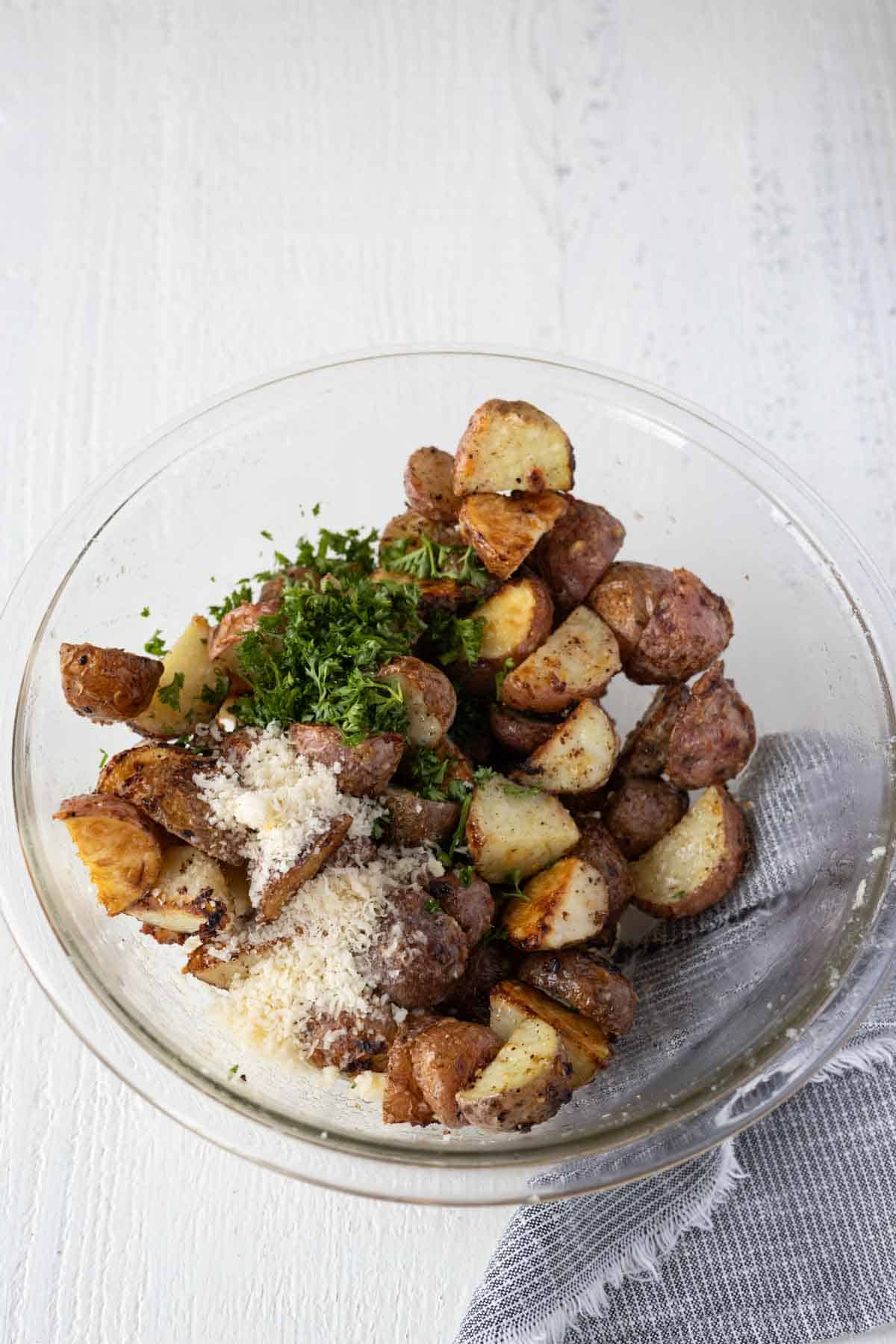 Golden brown roasted red potato pieces with parmesan cheese and minced parsely.